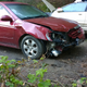 A large tree fell in front of the car while it was parked and one of the branches caught the front end.